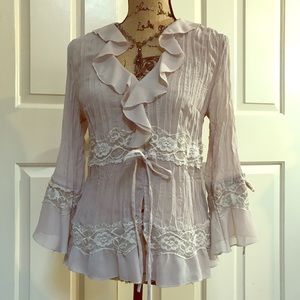 Cream sheer blouse with lace and ruffle details
